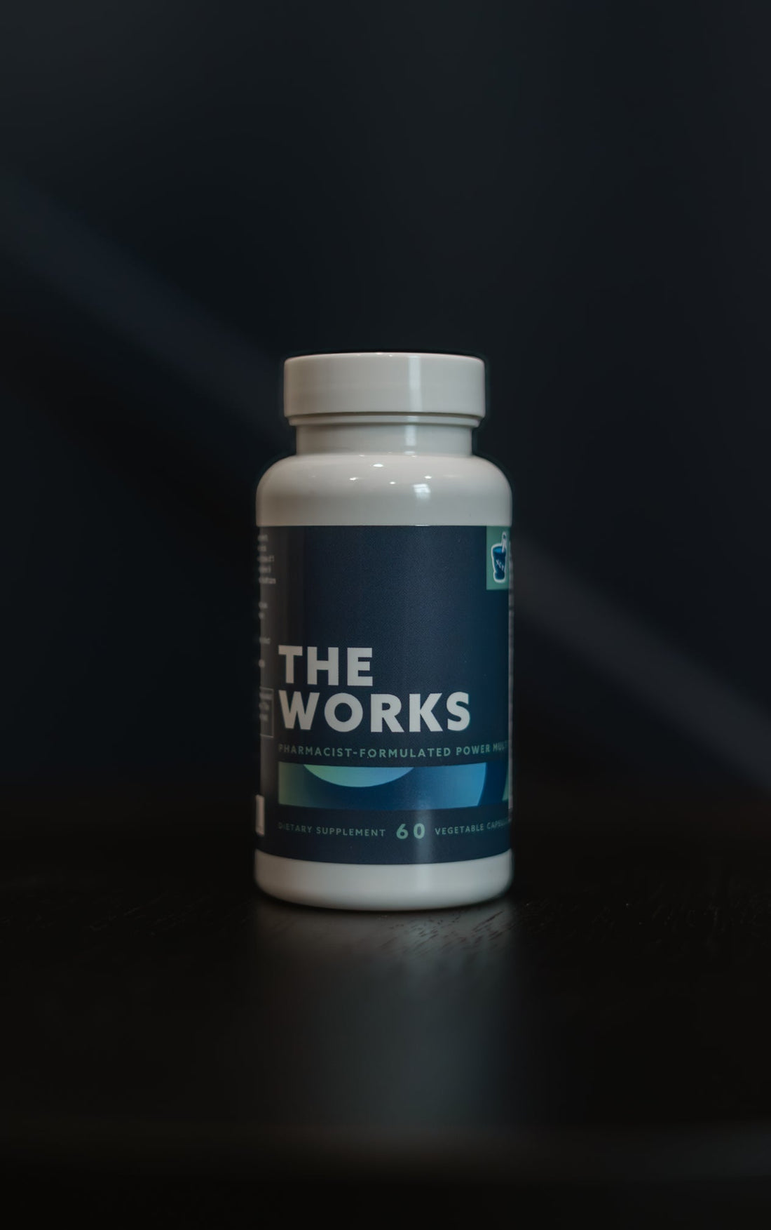 Image of THE WORKS bottle with the new branding of navy background and white text on the front