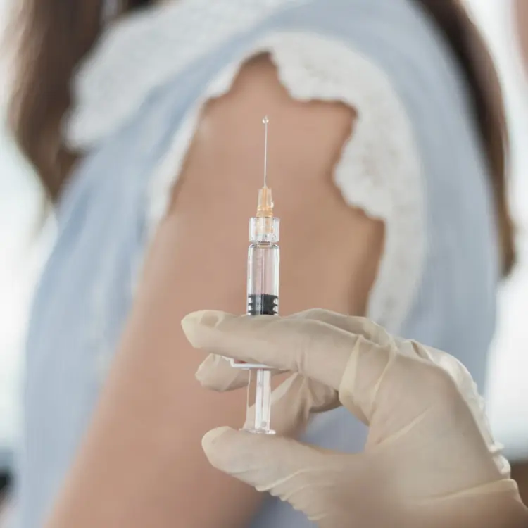Pharmacist giving patient vaccine